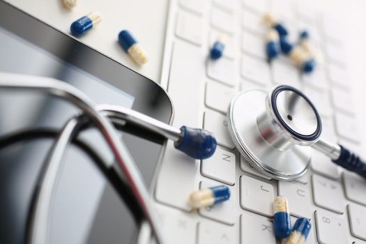 Tablets and stethoscope on computer keyboard with tablet. Remote receipt of medical prescription concept