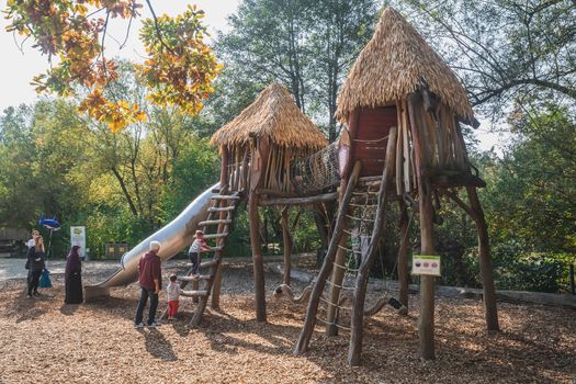 Ljubljana, Slovenia, October 2020: Parents play with their children at the playground at the Ljubljana Zoo