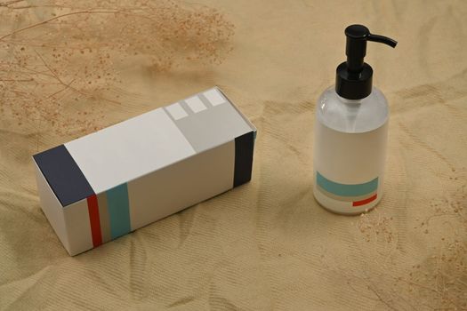 Shampoo or soap plastic bottle dispenser on cotton silk fabric. Natural skincare, beauty product design concept.