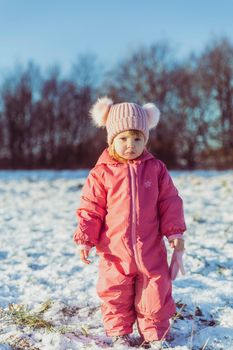 charming beautiful baby walks in winter park.