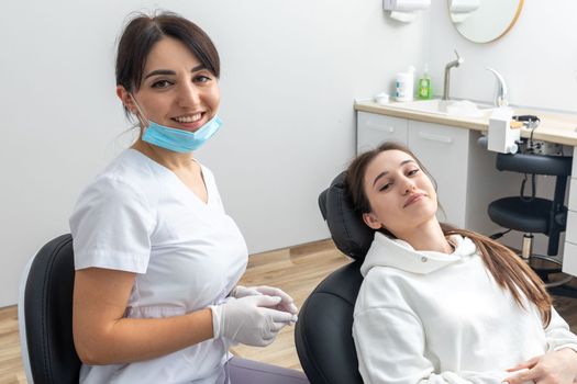 Orthodontist checking brackets on female teeth. Concept of stomatology, dentistry and orthodontic treatment of braces