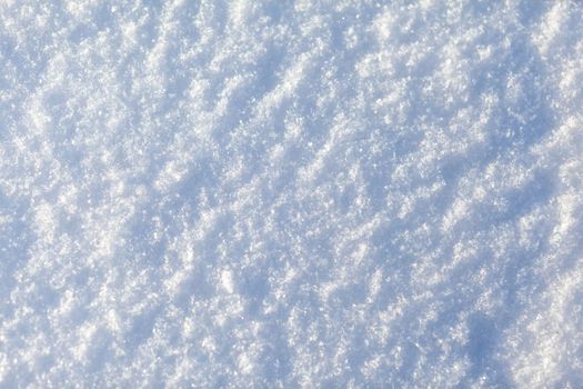 Clean, white snow close-up. Winter background. Snow surface. Fresh fluffy white snow texture.White snowflakes. High quality photo