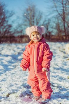 charming beautiful baby walks in winter park.