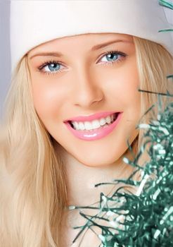 Happy holidays, Merry Christmas, and a woman wearing a white benny hat, beauty, and fashion. Portrait of a lovely blonde woman grinning and enjoying the Christmas, New Year, and winter vacations.