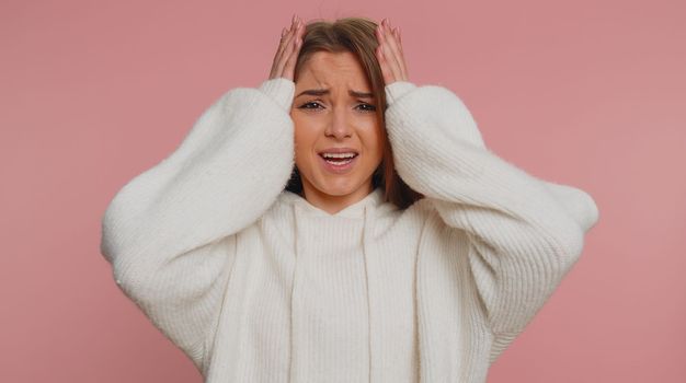 Young pretty woman feeling hopelessness loneliness, nervous breakdown, loses becoming surprised by lottery results, bad fortune, loss, unlucky news. Caucasian girl isolated on studio pink background