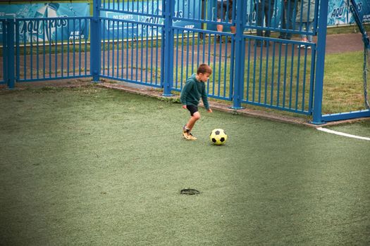 Genk, BELGIUM, August 18, 2021: football player boy scores a goal in football on a green lawn, motion blur, High quality photo