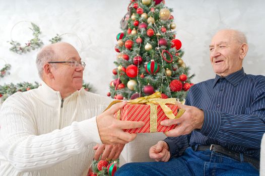 Son giving gift box to father. Man giving Christmas present to elderly father. Happy people family concept. Happy Christmas, xmas concept