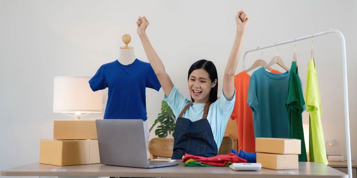 Young asian women happy after new order from customer. Surprise and shock face of asian woman success on making big sale of his online store. Online Selling.