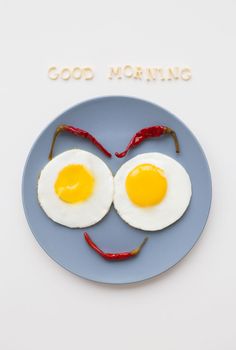 cheerful breakfast, two eggs on a plate, the inscription Good Morning