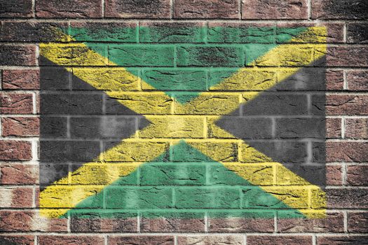 A Jamaica flag painted on brick wall background