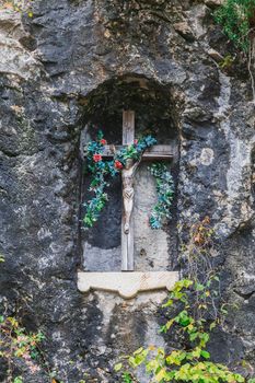 Wooden cross with a crucifix in the rock.