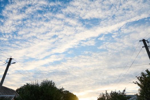 Low angle view. Bottom view of a blue clean sky with white fluffy clouds. Cloudscape