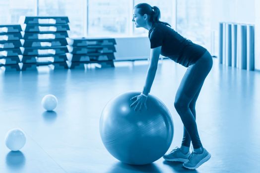 Woman at the gym with a pilates ball