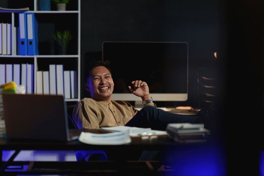 Asian business man working over time at night. business account and finance concept.