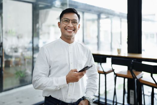 business owner or Asian male marketers are using business phones in office work.
