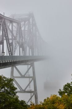 Image of View from outside of huge steel bridge fading away into nothing on extreme foggy weather morning