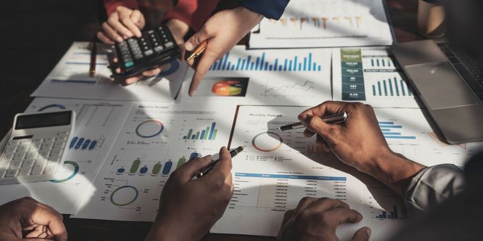 Business financial, accountant discussing with partner are meeting to audit finance planning sales to meet targets set in next year. stock market concept....