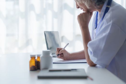 Doctor having conversation with patient while discussing explaining symptom and hold hand for encourage.