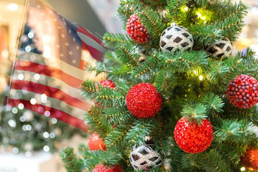 Christmas tree decoration in shopping mall with usa flag on background