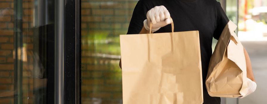 delivery guy in protective mask near the customer house, outdoors