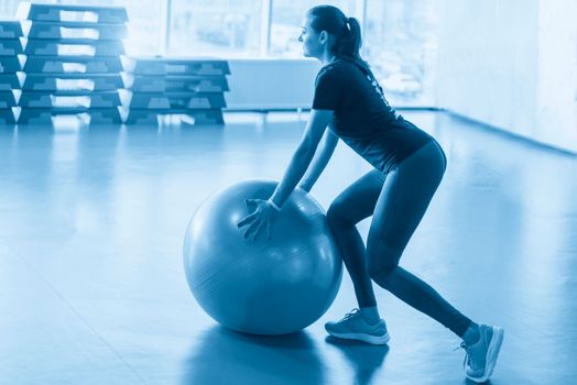 Woman at the gym with a pilates ball