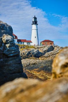 Image of Lighthouse in Maine through soft focused rocks