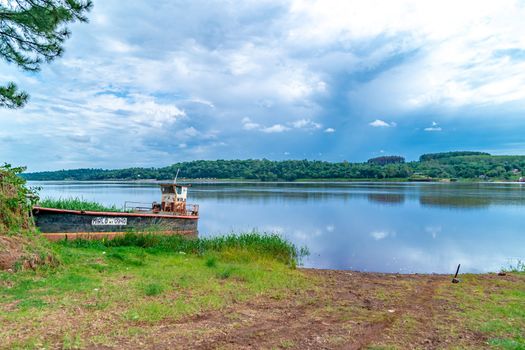 rusty cargo ship by the river. 