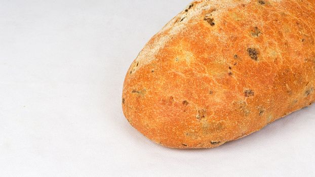 Olive loaf, olive bread, a bread laced with whole olives on white background