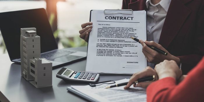 Real estate agent offer hand for customer sign agreement contract signature for buy or sell house. Real estate concept contact agreement concept..