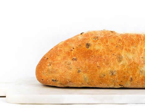 Olive loaf, olive bread, a bread laced with whole olives on white background