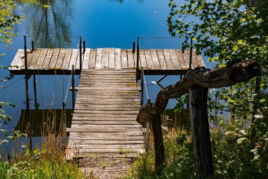 An old jetty on a lake with a traditional railing