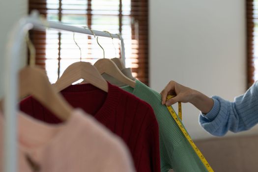 Young person using credit card and laptop computer. Online shopping, e-commerce concept.