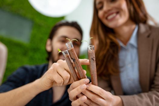 University biologists colleagues taking experiment on sprout and checking the analysis of the sample of plant in the lab tube.       