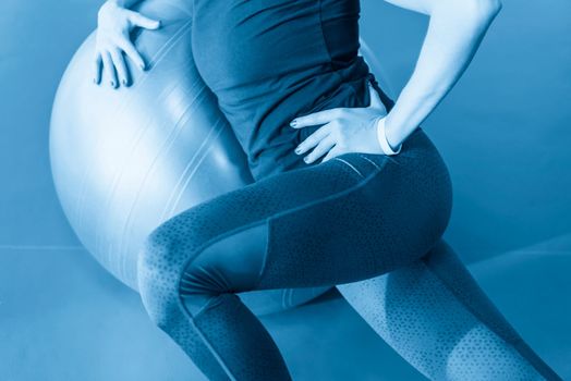 Woman at the gym with a pilates ball