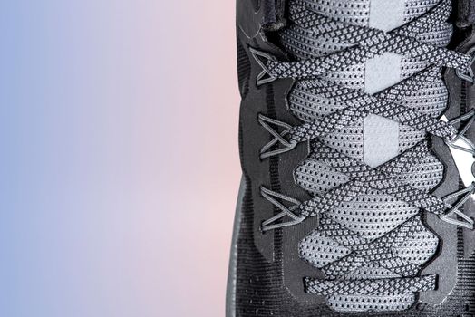 Sneakers close-up. Shoelaces of new sports shoes in gray, lacing sneakers close-up, top view. Mesh elastic laces for fitness. Sport and active lifestyle concept