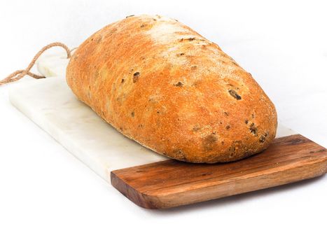 Olive loaf, olive bread, a bread laced with whole olives on white background