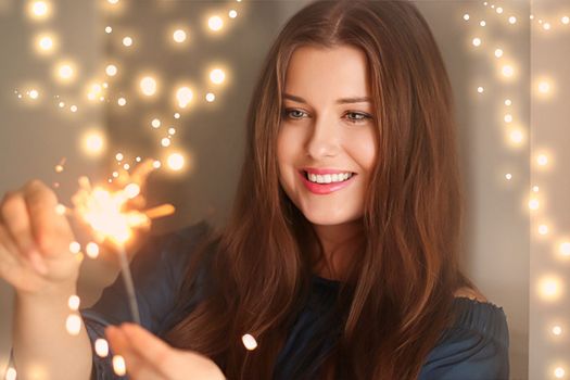 Holiday magic, Christmas and New Year celebration, happy woman with sparklers, portrait