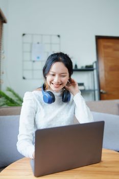 Portrait of a beautiful Asian teenage girl using a computer.