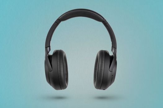 Headphones on a blue background. Wireless headphones in black, high quality, for advertising or product catalog