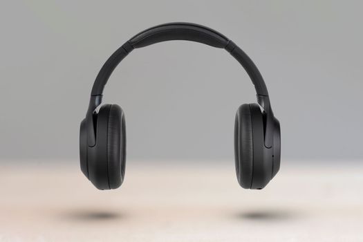 Headphones on a light background. Wireless headphones in black, high quality, for advertising or product catalog