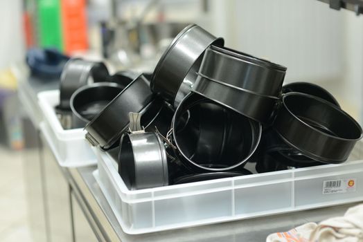 bunch of washed cake pans in professional kitchen high res image