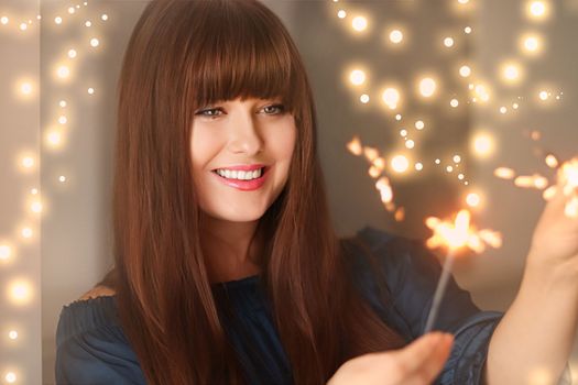 Holiday magic, Christmas and New Year celebration, happy woman with sparklers, portrait