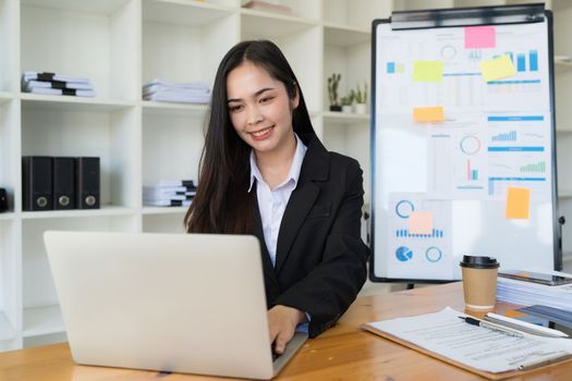 Pleasant positive business woman using laptop at home office.