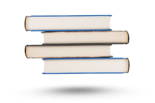 stack of books, isolate on white background. A stack of books of varying thickness falls, casting a shadow. Books are isolated on a white background, hanging in the air