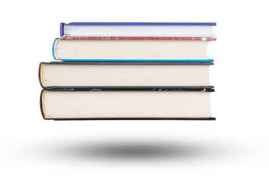 stack of books, isolate on white background. A stack of books of varying thickness falls, casting a shadow. Books are isolated on a white background, hanging in the air