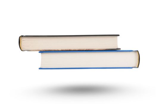 stack of books, isolate on white background. A stack of books of varying thickness falls, casting a shadow. Books are isolated on a white background, hanging in the air