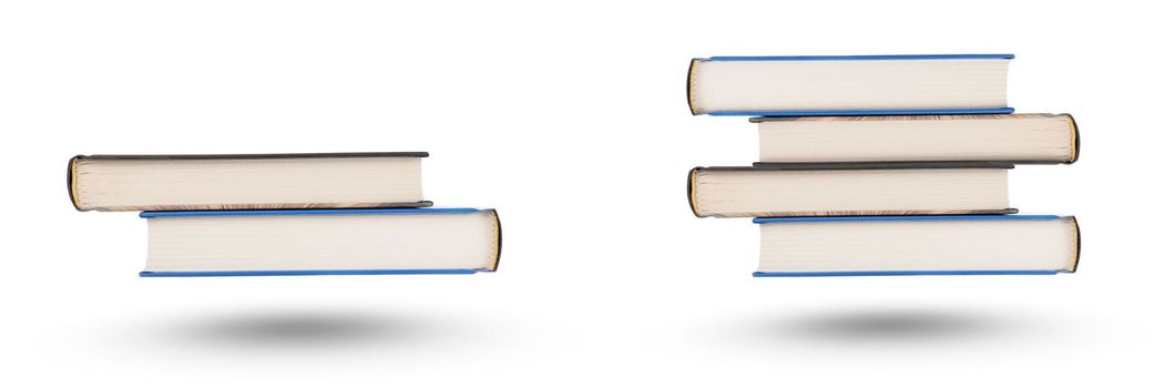 stack of books, isolate on white background. A stack of books of varying thickness falls, casting a shadow. Books are isolated on a white background, hanging in the air