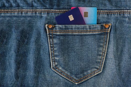 Credit cards in your pocket. Credit cards in the pocket of blue jeans. The concept of purchases and expenses, unplanned expenses