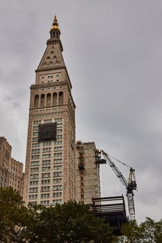 Image of New York City building with front clock covered for construction