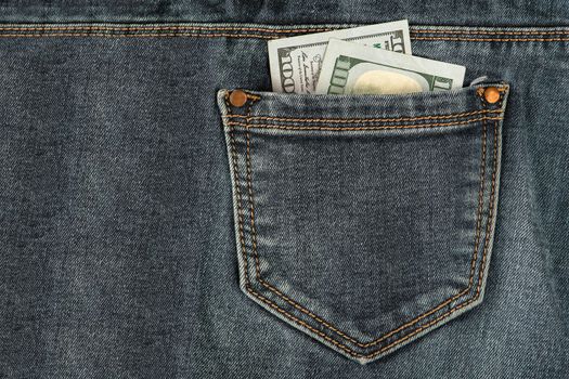 Stack of 100 dollar bills in jeans pocket. Money in the back pocket of my jeans. The concept of investment, cash, wealth and profit.